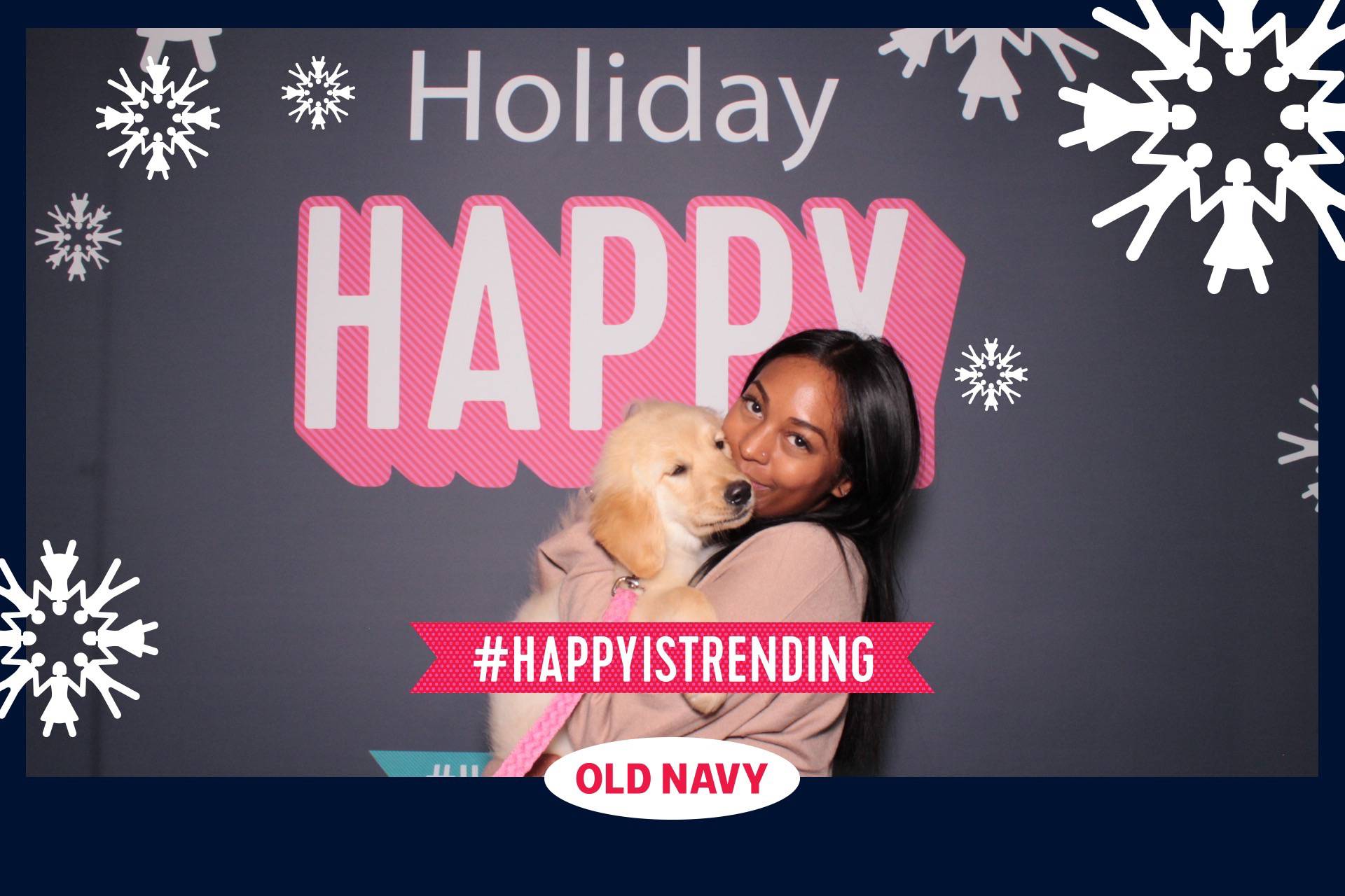 a photo booth photo at an Old Navy branding activation in Los Angeles with live puppies as props