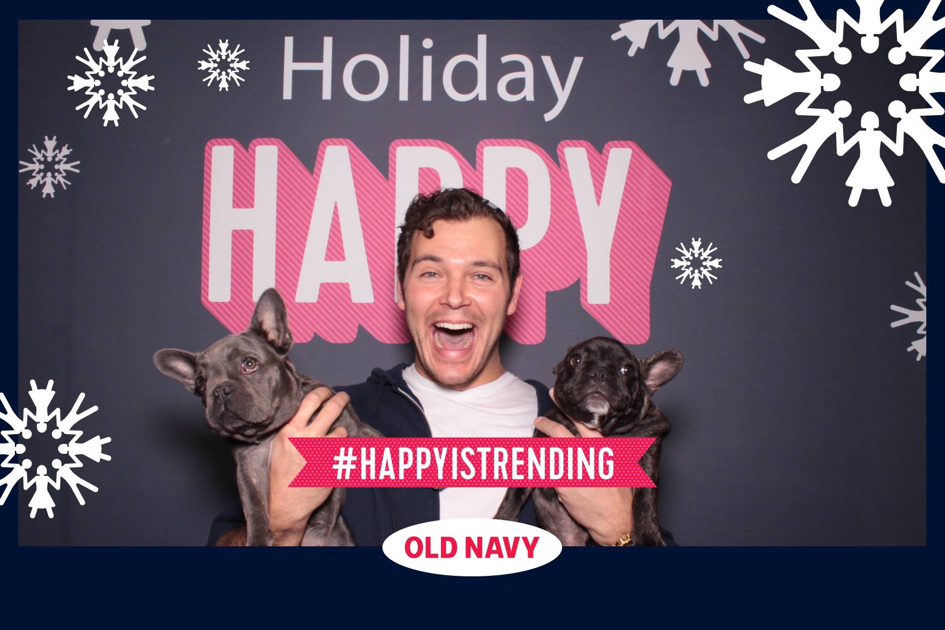a photo booth photo at an Old Navy branding activation with live puppies as props
