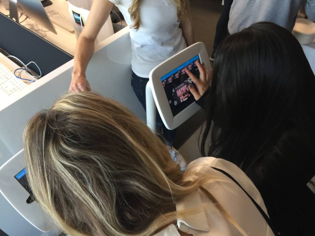 Party guests sharing their photo booth photos and gifs via Maple Leaf Photo Booth's iPad kiosks in Los Angeles