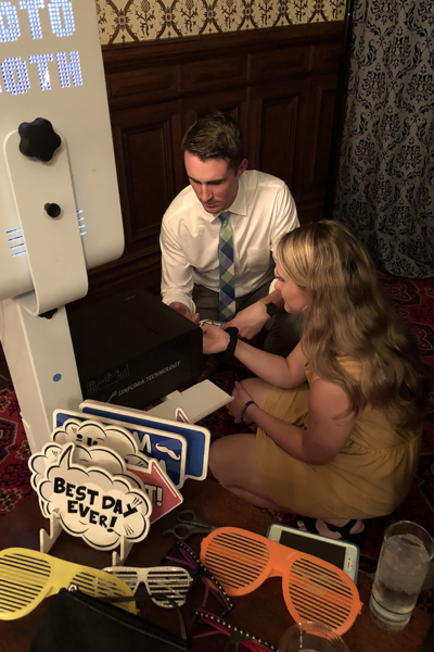 Chris Manitius founder maple leaf photo booths inc fixing a broken photo booth at a wedding